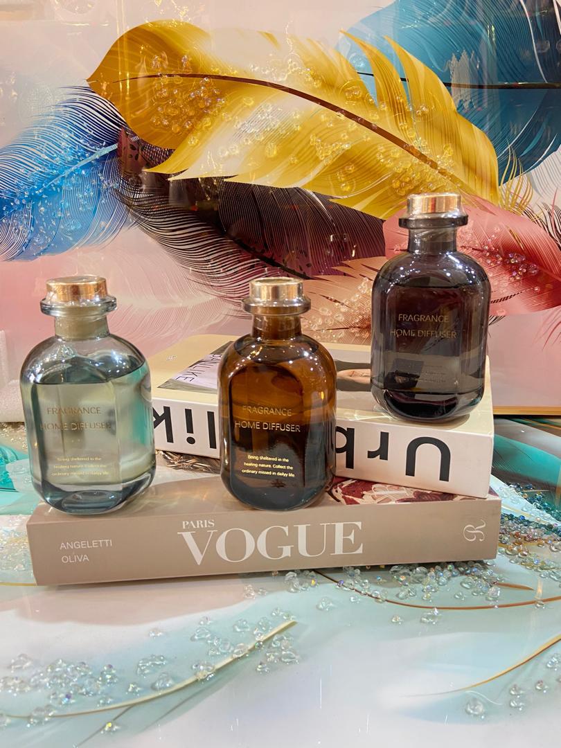 Home fragrance diffusers on decorative books