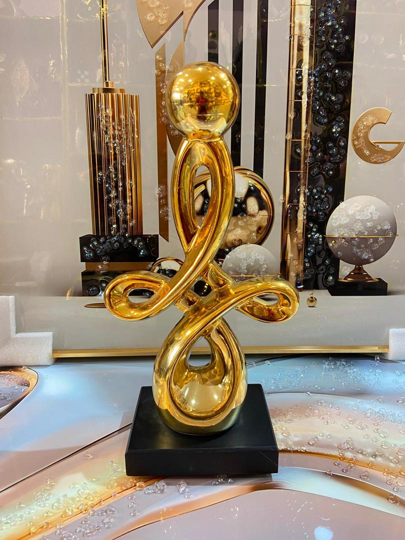Gold abstract flowing infinity sculpture