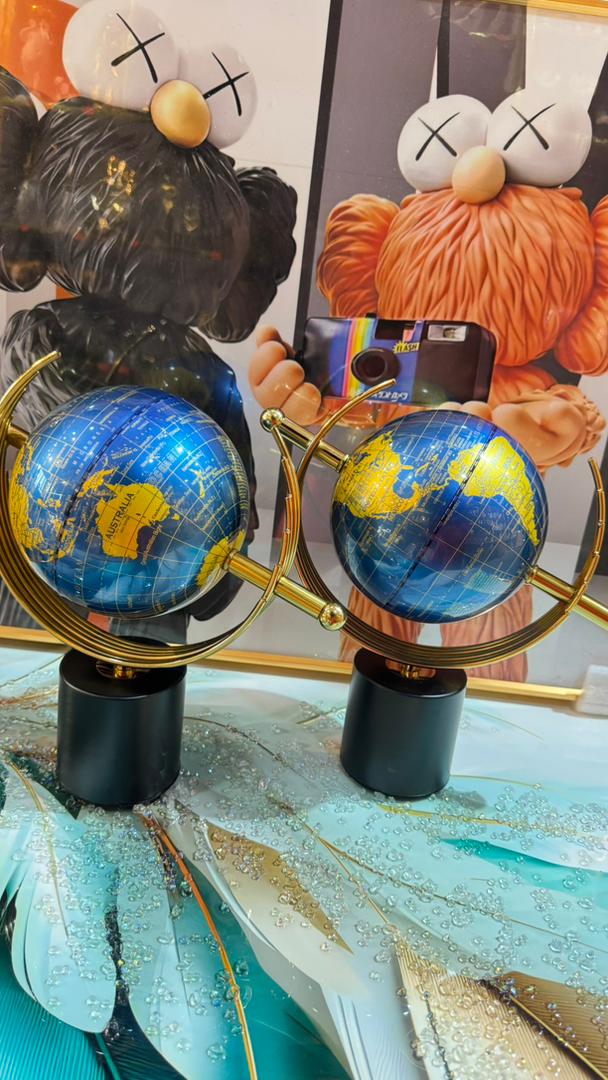 Blue and gold globe ornaments on black stands